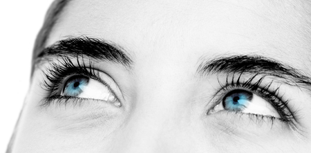 Pretty brunette looking at top  against white background with vignetteの写真素材