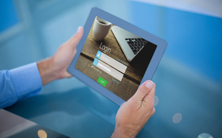 Businessman using his tablet  against close-up of login page