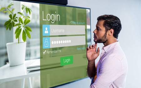 Close-up of login page against thoughtful man looking over whiteboard