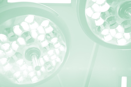 Low angle view of surgical lights in operation theater at hospitalの写真素材