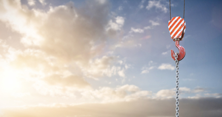Studio Shoot of a crane lifting hook against cloudy sky landscape