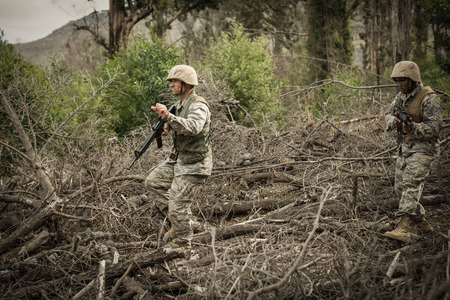 Military soldiers during training exercise with weapon at boot camp