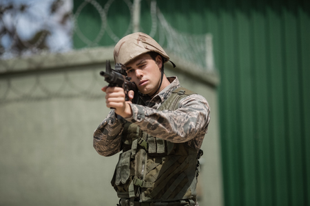 Military soldier aiming with a rifle in boot campの写真素材