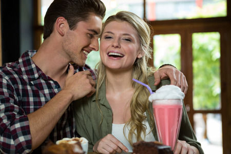 Romantic young couple spending quality time in coffee shopの写真素材