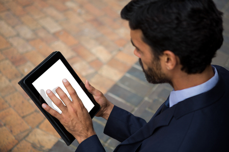 Businessman using digital tablet in conference centreの写真素材
