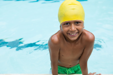 Portrait of smiling boy standing in swimming poolの写真素材