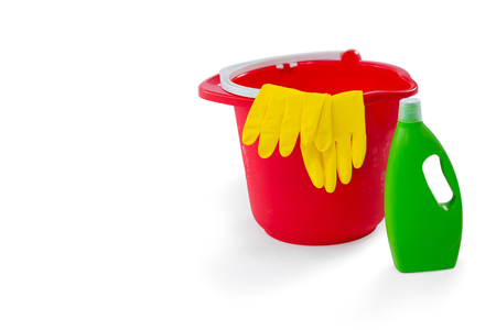 Close up of chemical bottle by glove in bucket against white backgroundの写真素材