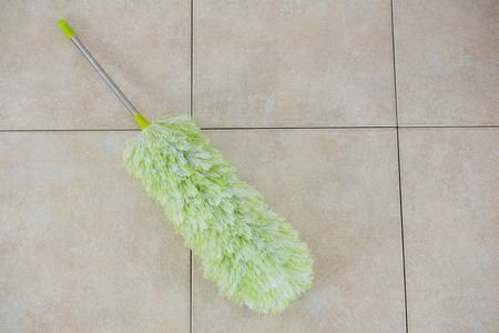 High angle view of duster on tiled floor
