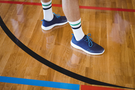 Low section of basketball player standing in the courtの写真素材
