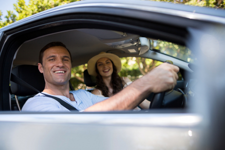 Low angle view of cheerful couple sitting in carの写真素材