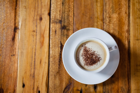 Close up of coffee cup on wooden tableの写真素材