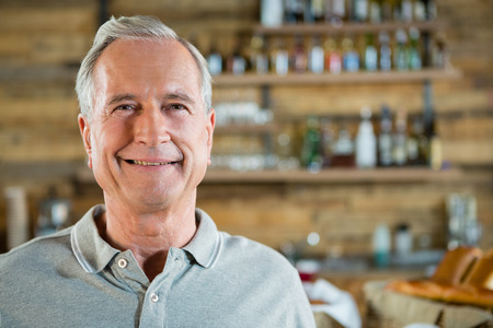 Portrait of smiling senior man in cafÃ©の写真素材