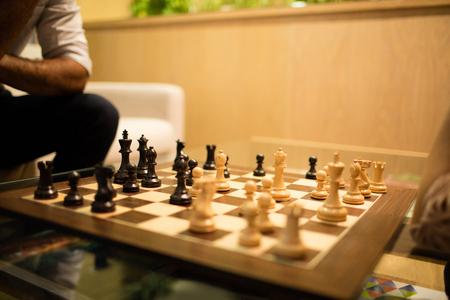 Close up of chess board on glass table n officeの写真素材