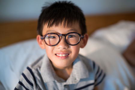 Close-up of boy in spectacles looking at cameraの写真素材