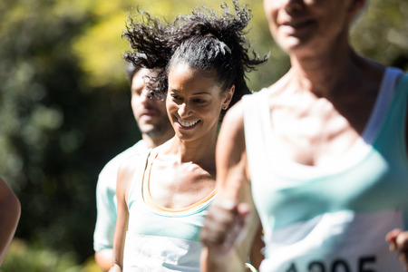 Happy marathon athlete walking in the parkの写真素材