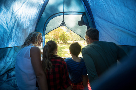 Rear view of family sitting in the tentの写真素材