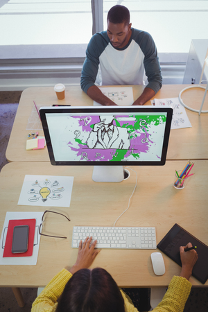 High angle view of male and female designer working in creative officeの写真素材