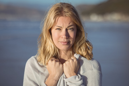 Portrait of young woman at beach during sunny dayの写真素材