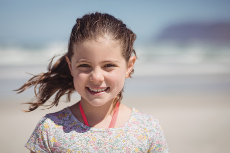 Portrait of smiling girl at beach during sunny dayの写真素材