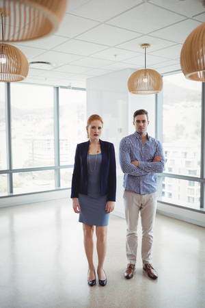 Portrait of smiling executives standing together in officeの写真素材