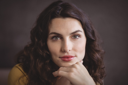 Portrait of beautiful woman sitting in restaurantの写真素材