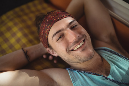 Portrait of happy young man relaxing in mini vanの写真素材
