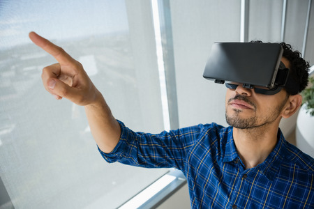 Executive using virtual reality headset in office
