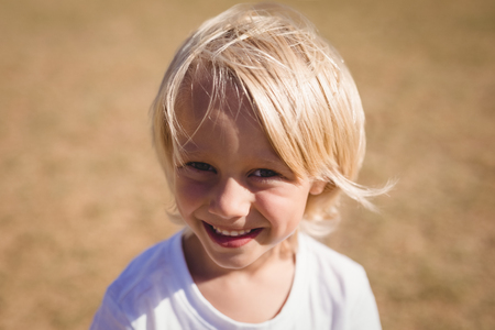 Close-up of smiling schoolgirl in park on a sunny dayの写真素材