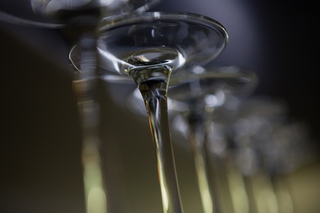 Low angle view of wine glasses at bar counterの写真素材