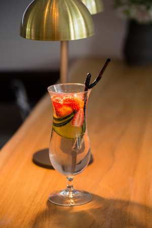 High angle view of cocktail by lighting equipment on table restaurantの写真素材