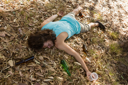 Unconscious drunken man sleeping in the parkの写真素材