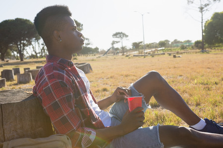 Thoughtful man resting in the park on a sunny dayの写真素材