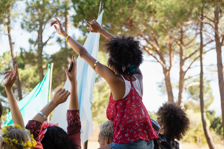 Group of female friends having fun in the music festival at the parkの写真素材