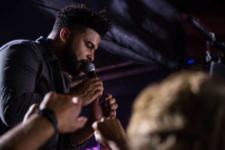 Singer performing on stage in nightclubの写真素材