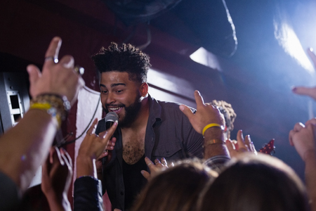 Singer performing on stage in nightclubの写真素材