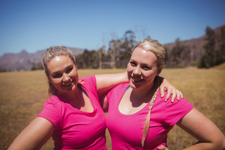 Two women standing together in the boot camp on a sunny dayの写真素材