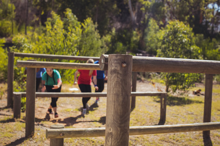 Group of fit women training on fitness trail in the boot campの写真素材