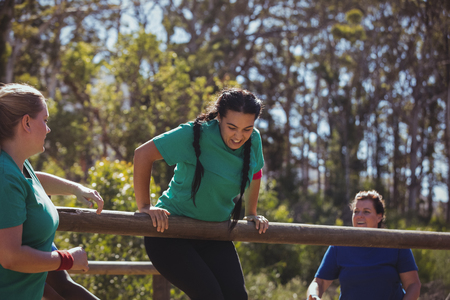 Fit women training on fitness trail in the boot camp on a sunny dayの写真素材