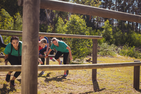 Group of fit women training on fitness trail in the boot campの写真素材