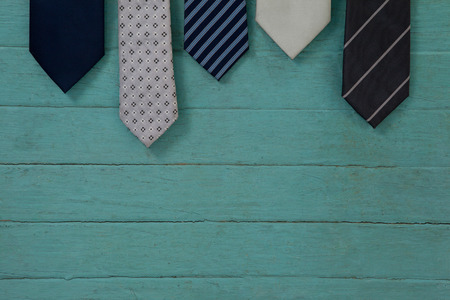 Close up of various neckties hanging on green wooden wallの写真素材