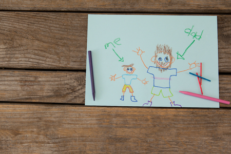 High angle view of fathers day greeting card and crayons on wooden tableの写真素材