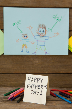 Fathers day greeting cards and crayons on wooden tableの写真素材