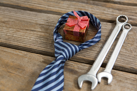 High angle view of gift box with necktie and work tools on tableの写真素材
