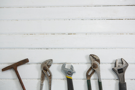 Overhead view of carpentry tools on white wooden tableの写真素材