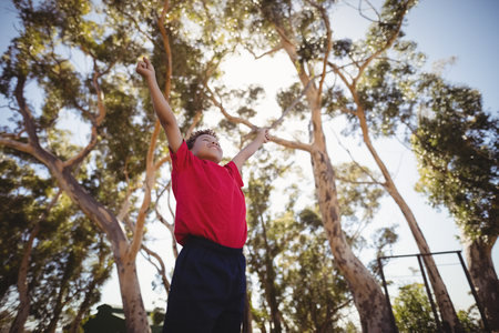 Boy cheering during obstacle course in boot camp