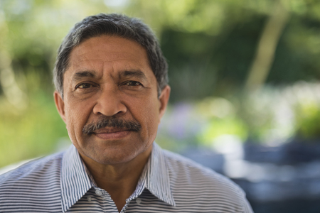 Portrait of serious senior man at porch