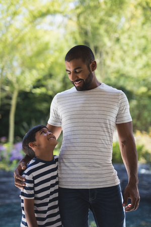 Smiling young man with his son standing at porchの写真素材