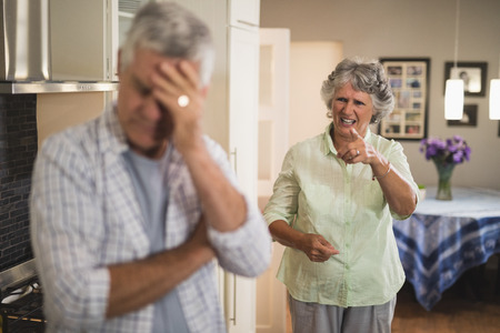 Angry senior woman shouting on senior man at homeの写真素材