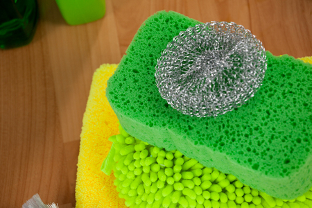 Close-up of various cleaning equipment on wooden floorの写真素材