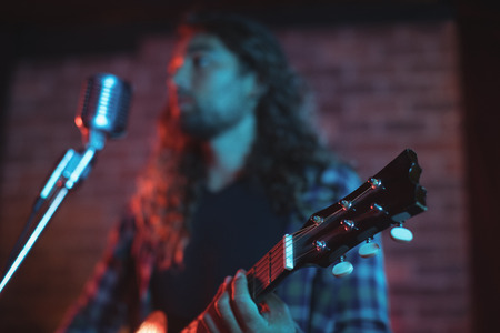 Low angle view of male singer performing in nightclubの写真素材